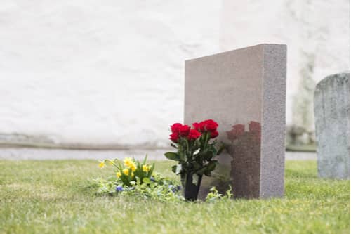 Grave with red roses, Atlanta wrongful death lawyer concept