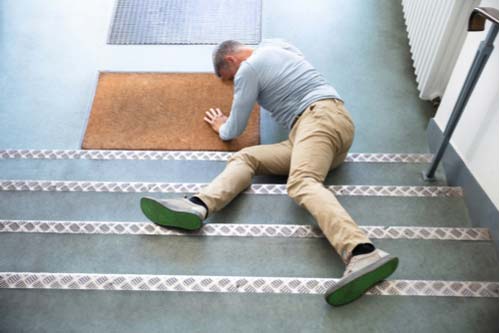 Man fallen down stairs, Riverdale slip and fall lawyer concept