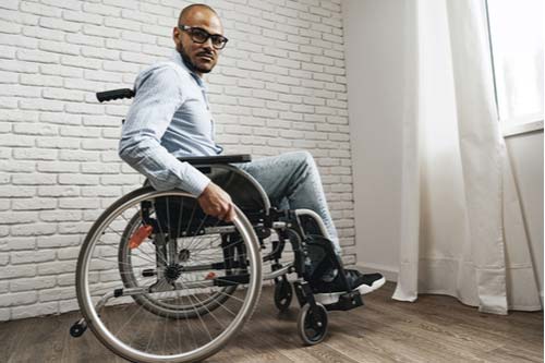African Amercian man in wheelchair, Riverdale spinal cord injury lawyer concept