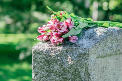 Pink flowers on grave, College Park wrongful death lawyer concept