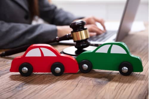 Judge gavel and toy cars, East Point car accident lawyer concept