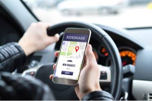 Blog Driver using rideshare app, Riverdale Uber accident lawyer concept