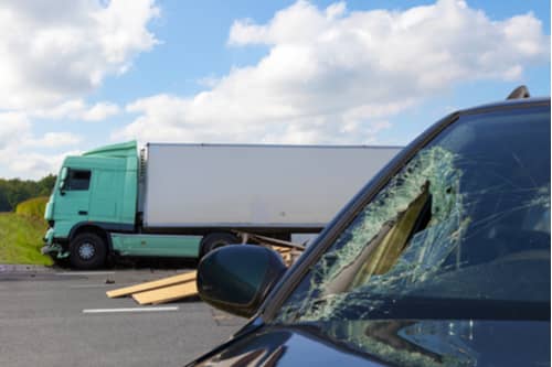 Car with broken windshield in truck crash, Riverdale truck accident lawyer concept