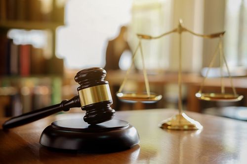 Gavel and scales of justice on the desk of a Fairburn car accident lawyer